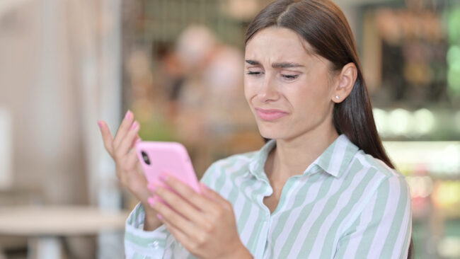 Young Latin Woman Having Loss On Smartphone